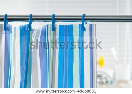 Blue shower curtain in the bathroom Royalty-Free Stock Photo #48668851
