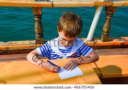 boy on the ship writes on a piece of paper