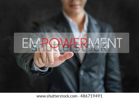 Business word Business man point EMPOWERMENT on white tab virtual screen in dark background.