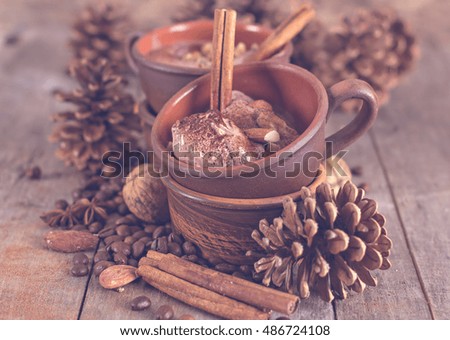 Chocolate and coffee ice cream with spices on the old wooden boards. Coffee, cinnamon, nuts, star anise. Winter, New Year, Christmas still life