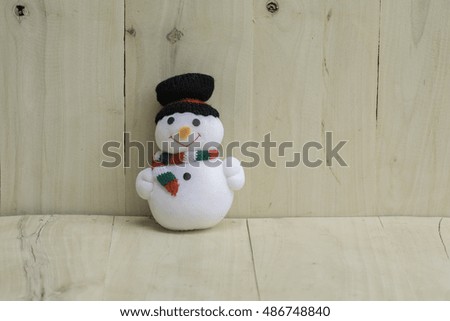 Snowman doll on a wooden floor