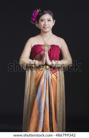 woman wearing typical thai dress with black background, identity culture of thailand