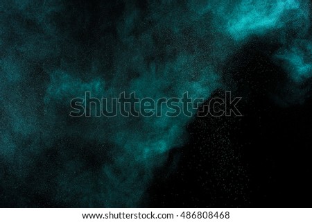 Aquamarine  powder explosion on black background. Green color cloud. Colored dust explode. Freeze motion paint  Holi.