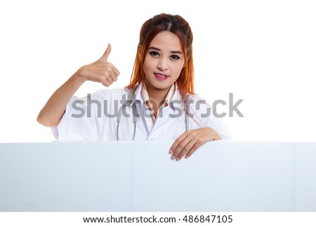 Young Asian female doctor show thumbs up  behind blank white billboard  isolated on white background.