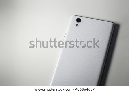 Blank back of a modern phone. White smartphone on a white background.