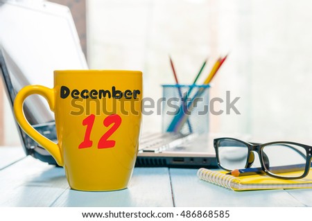 December 12th. Day 12 of month, Calendar on cup morning coffee or tea, Database Administrator workplace background. Winter time. Empty space for text