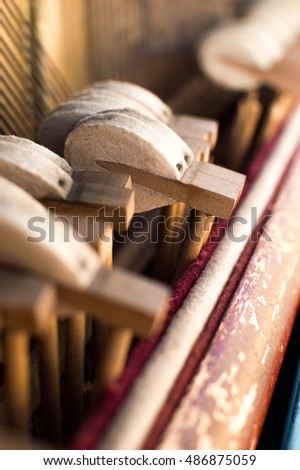 Mechanic hammers and strings inside old piano