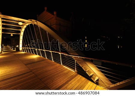 Bridge yellow light illuminated in the night with black background Night photography of Hamburg ,View into a channel at the Speicherstadt, historic warehouse district at Hamburg harbor in twilight