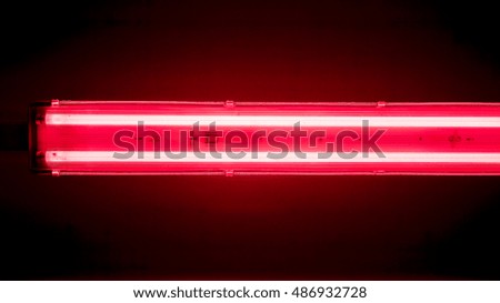 horizontal long lamp against dark background, horizontal lamps divided into sections with lights against dark background, high quality resolution, ceiling office lamp with light
