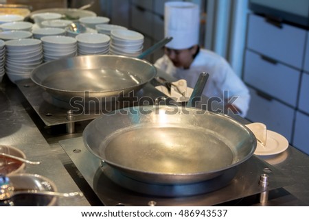 Chinese wok pan with oil in the kitchen at restaurant and Chef prepare to cook for serving in background picture