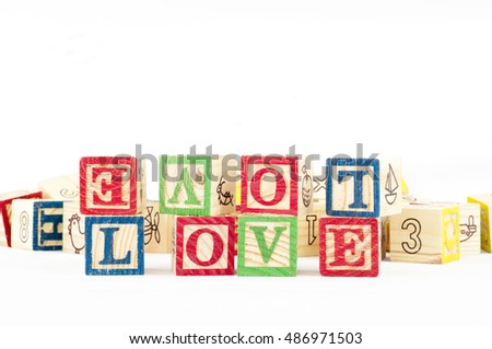 the word LOVE formed from cubical wood letter box. 