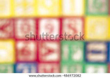 The off focused image of cubical wooden with letter arranged disorderly suitable for background.  