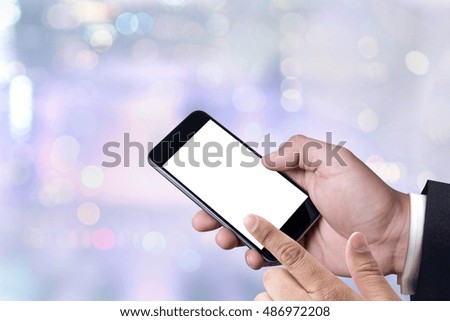 person holding a smartphone on blurred cityscape background man and phone