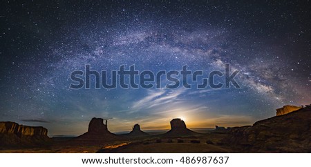 Milky way over monument valley with moon rise from background in border of Utah and Arizona, USA Royalty-Free Stock Photo #486987637