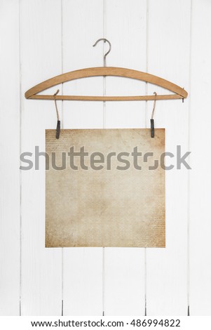 Old white brown paper hanging on a coat hanger. Mock up concept in old style empty and nobody.