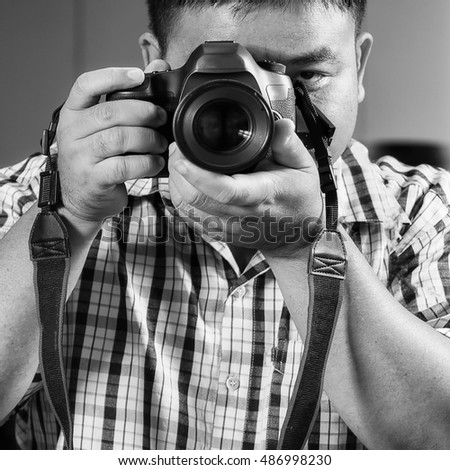 Photographer taking pictures with digital camera 