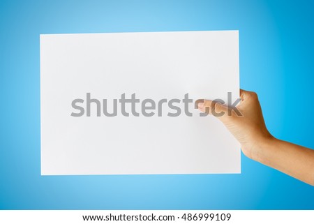 Hand holding paper isolated on blue,This picture has cut paths
