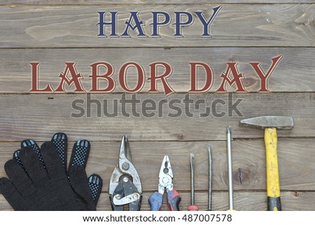 Happy labor day on the blackboard with tools for construction and repair work. The view from the top.