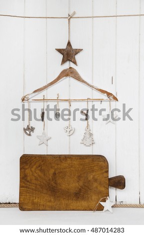 Christmas greeting card with an empty wooden brown sign and hanging christmas decoration.