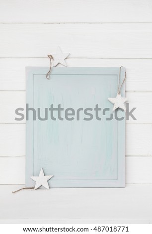 Simple blue turquoise christmas background with white stars on wooden background for a mock up presentation.