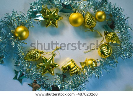 Christmas wreath. New Year or Christmas flat lay photo background for poster, greeting card, banner template. Fir tree ornament. Gold pine, ball, star on white background. Silver foliage ribbon frame