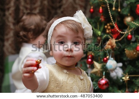 child decorate the Christmas tree toy