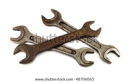 three old rusty wrenches on white background