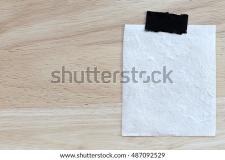 vintage of note paper on wooden background and copy specs you can input text to it.