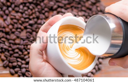 the barista have made picture from his imagine at coffee,pour milk on a cup