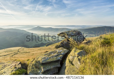 Sunrise at Grindslow Knoll in the Peak District, UK on a hazy summers morning. Royalty-Free Stock Photo #487116136
