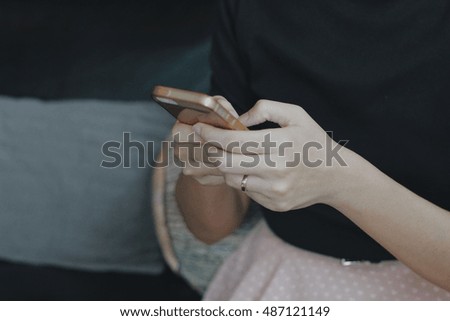 Hand using phone in room
