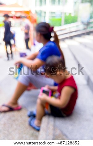 Blurred little boy plays games with smartphone
