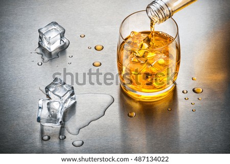 Glass of whisky on the rocks. Whisky on the rocks poured into glass