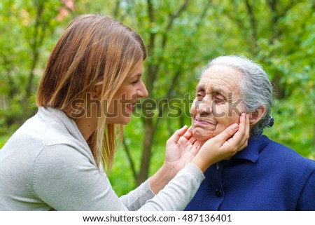 Picture of proud old woman with her loving granddaughter