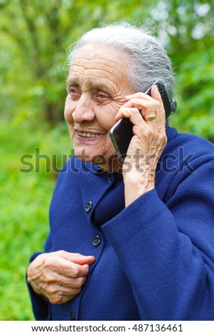 Picture of a happy senior woman talking on cell phone