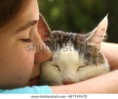 teen girl hug cat close up monochrome portrait on the summer garden background