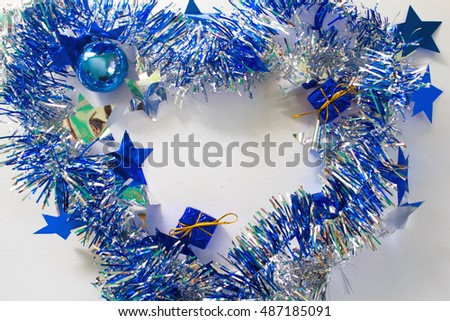 Christmas ornament in silver and blue on white background. New Year decoration flat lay. Shining and sparkling ribbon with text place. Blue glitter firtree. New Year or Christmas photo banner template