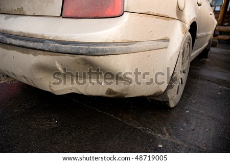 dirty white car with smashed bumper