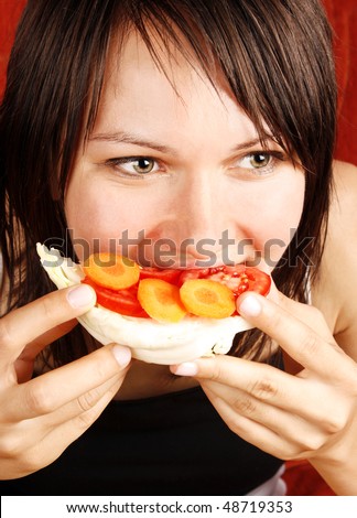 Beautiful woman eating a healthy sandwich