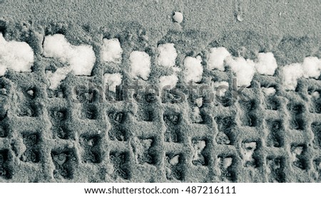 Car traces on sand.