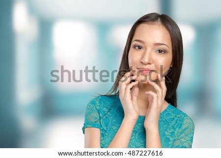 Casual mixed-race Asian Caucasian woman smiling looking happy