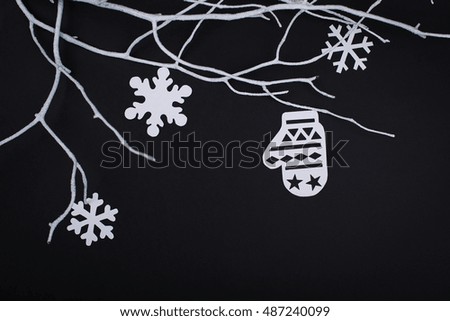 Merry Christmas card with snowflake decorations in paper cutting style over black.