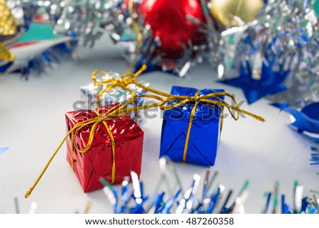 Christmas decoration with red and blue gifts on white background. New Year decoration flat lay. Wrapped presents with golden thread bow. Seasonal greeting card or banner template. Sparkling decor