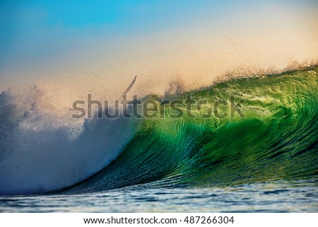 Surfer Crash in Ocean Wave at Sunset Time
