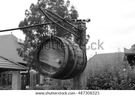 Wooden barrel hanging on metal chains