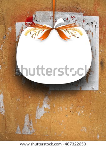 Close-up of one blank pumpkin shaped frame hanged by brown ribbon on cracked and scratched concrete wall background