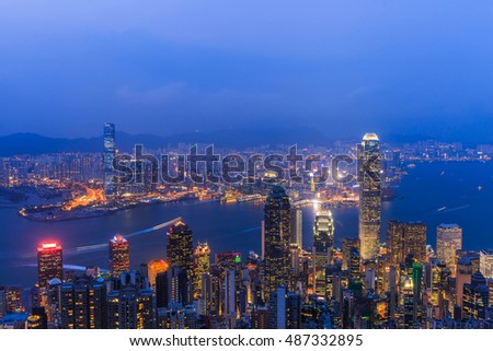 Hong Kong skyline Night view from Victoria Peak  with illuminated buildings at twilight. Victoria harbour view at night in Hong Kong.