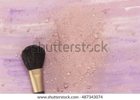 Makeup brush on a light purple watercolor background, with traces of powder and blush on it. A horizontal template for a makeup artist's business card or flyer design, with copyspace