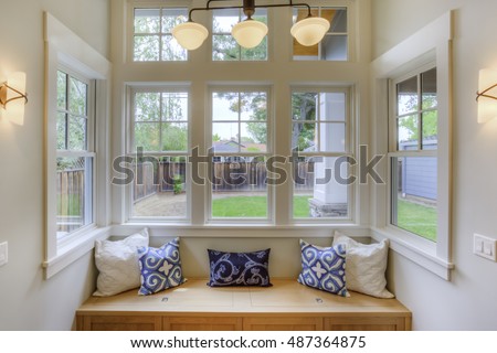 Window Seat with a view to the yard and large windows  Royalty-Free Stock Photo #487364875
