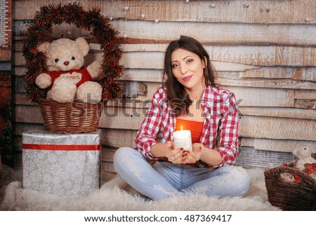romantic girl holds a candle. The concept of the New Year and Merry Christmas.